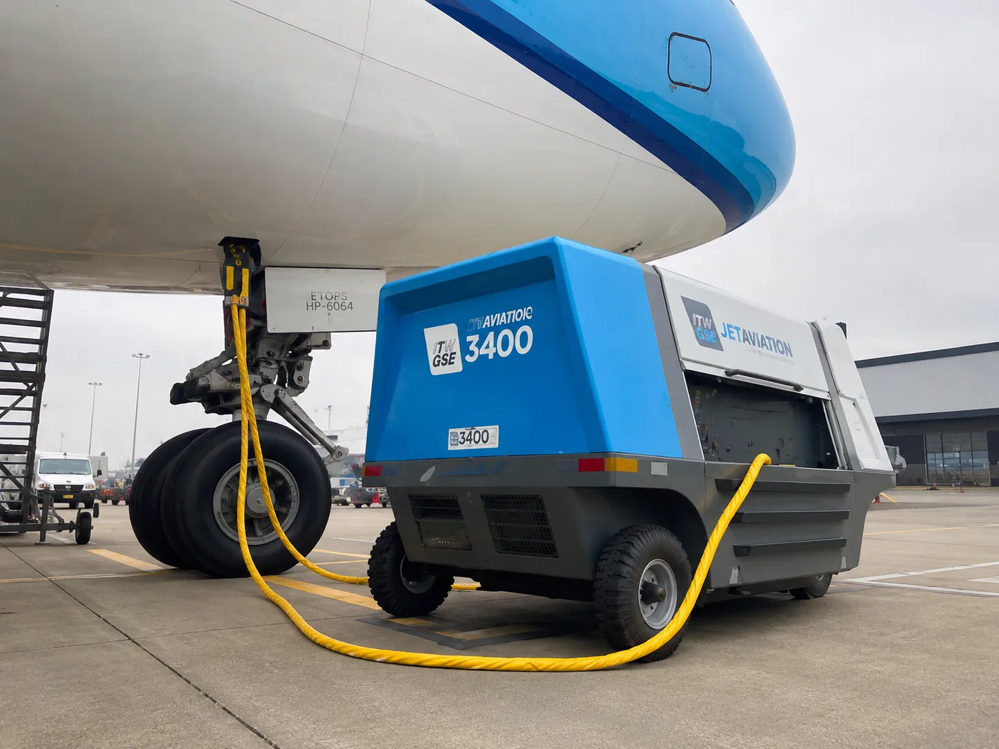 Ground Power Unit connected to a commercial aircraft on the ramp, supplying electrical power while the aircraft is on the ground.